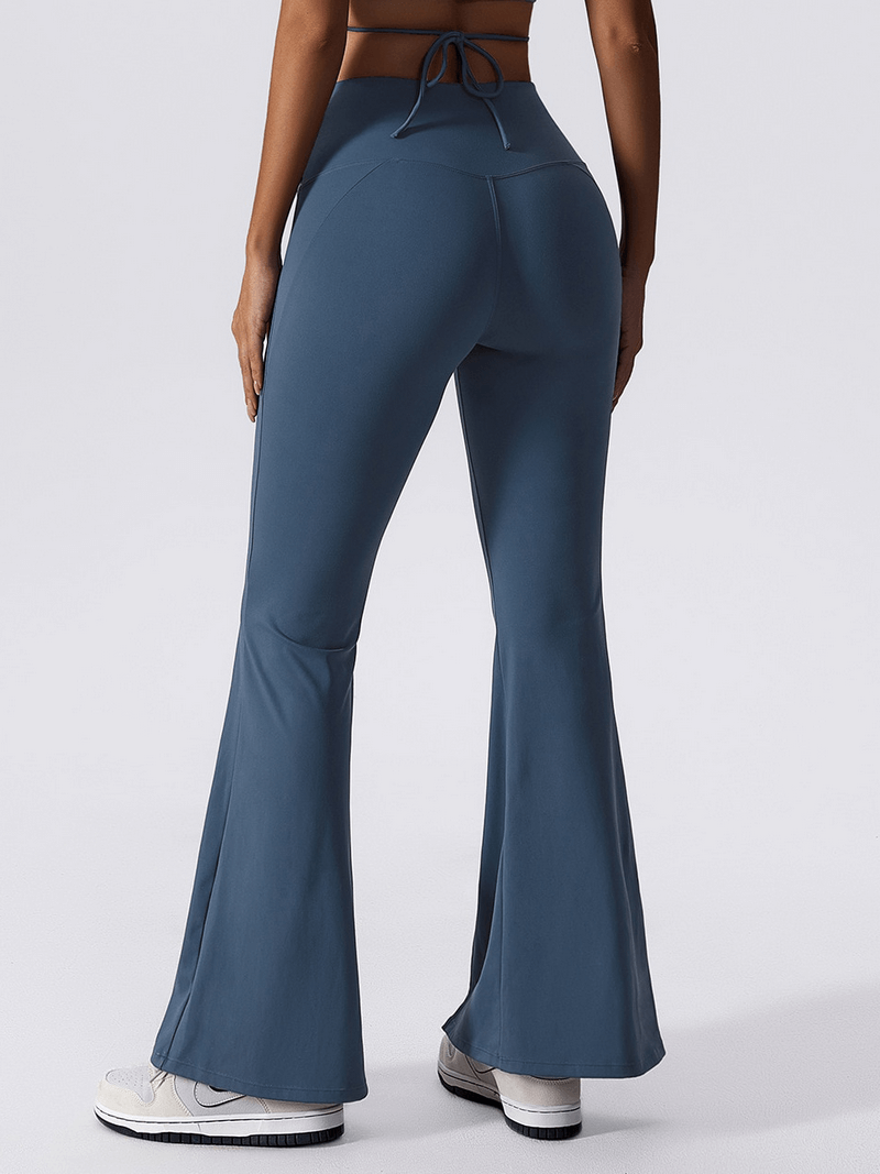Woman in blue wide-leg yoga high waist pants showcasing stretch and comfort, perfect for fitness activities like yoga and running.